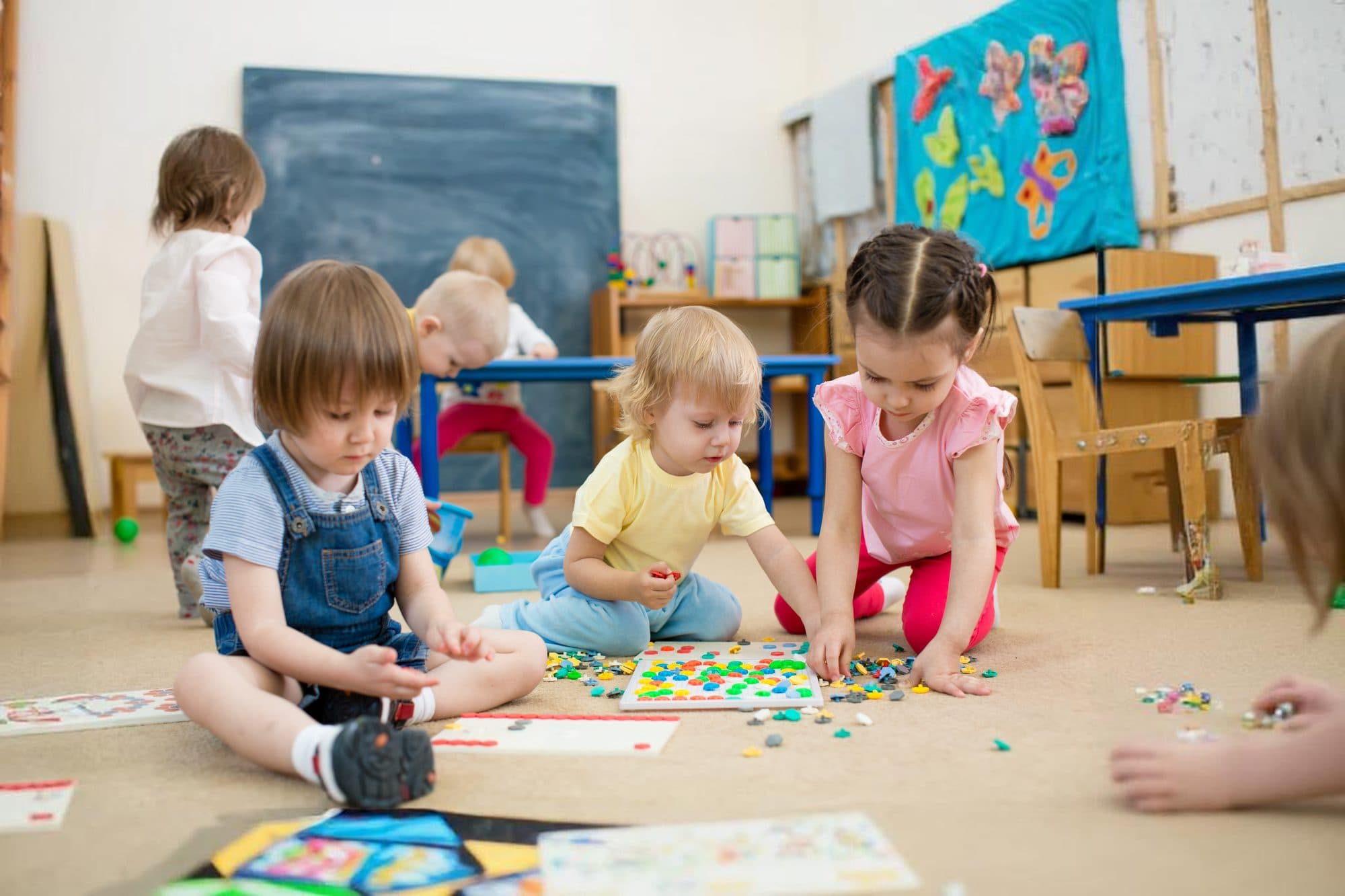Young children playing and learning together at Wee Discover